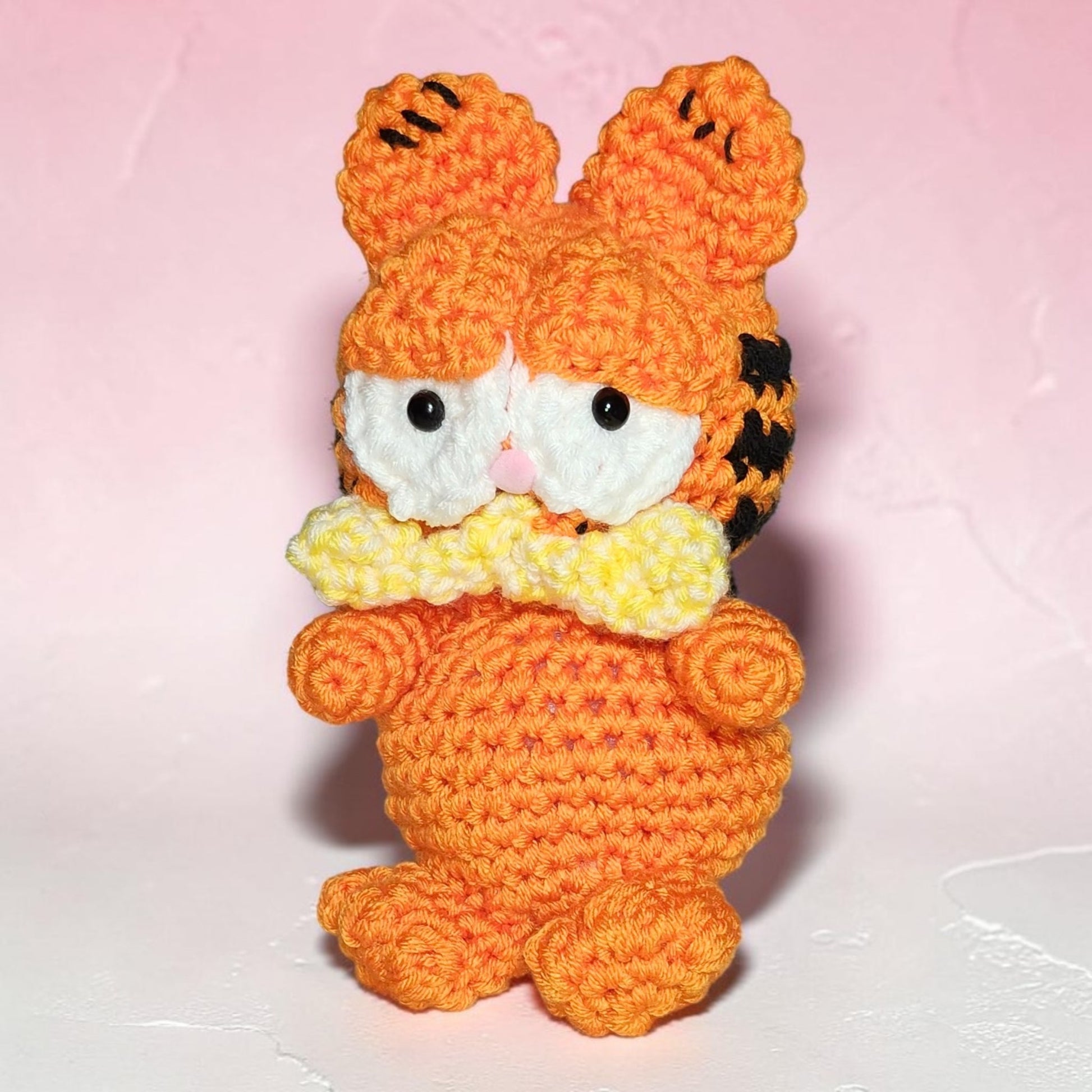 Handmade Garfield-inspired crochet plushie displayed against a neutral background.