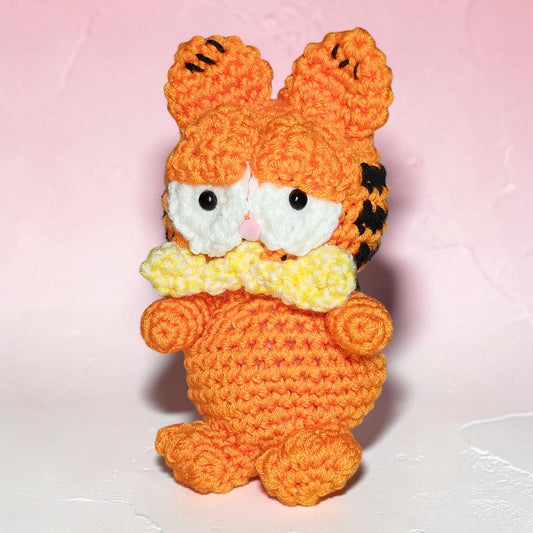 Handmade Garfield-inspired crochet plushie displayed against a neutral background.