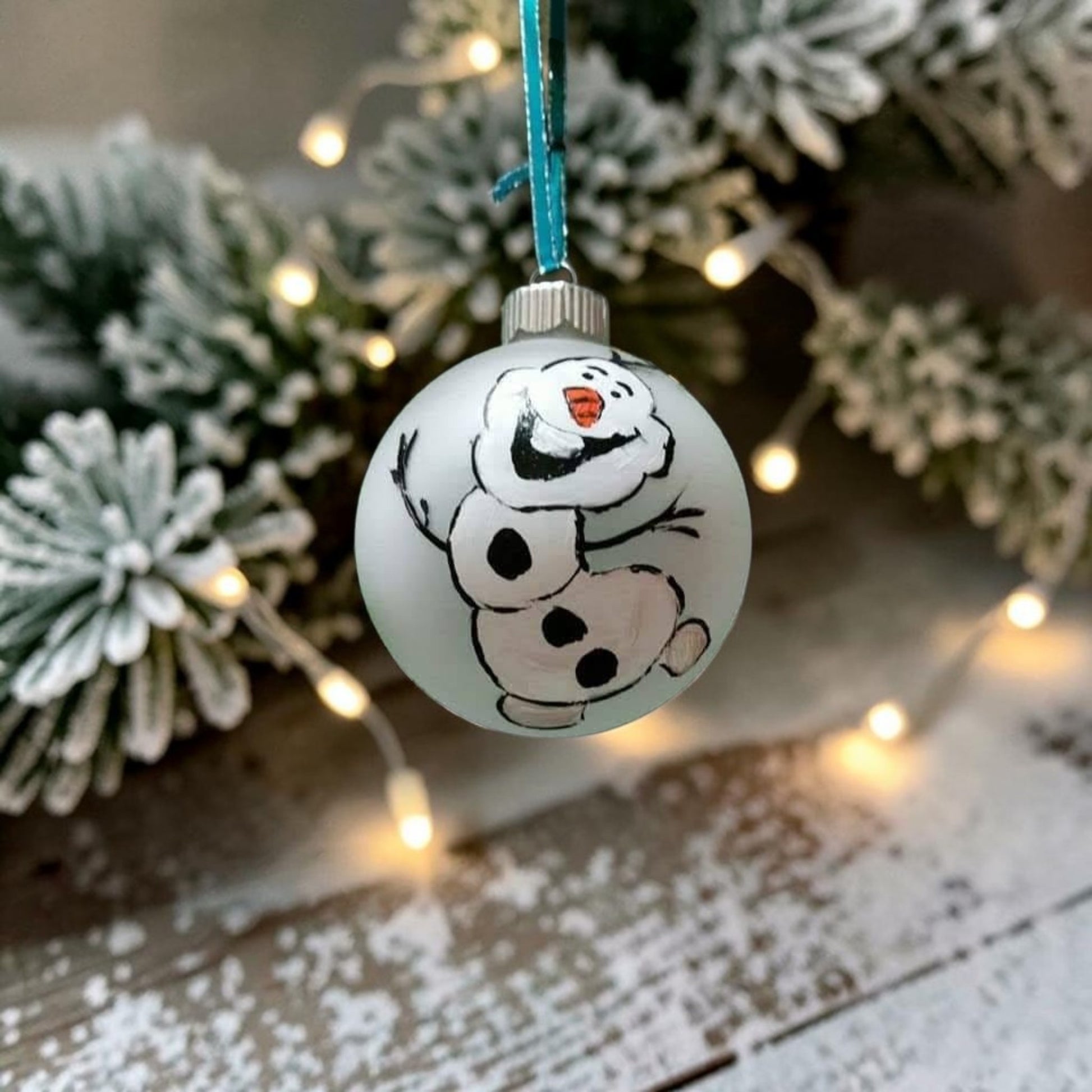 Hand-painted Olaf-inspired snowman glass Christmas ornament with carrot nose and twig details