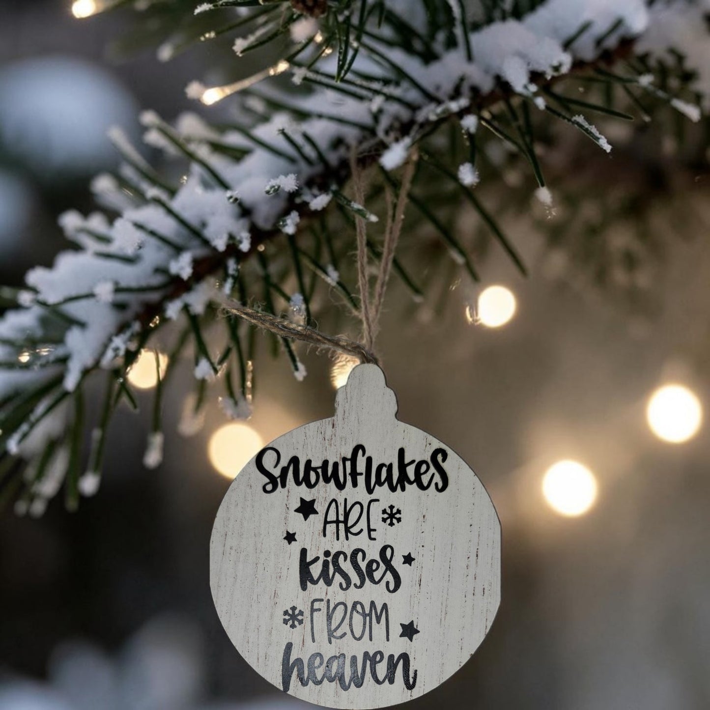 Snowflakes Are Kisses From Heaven handmade wood Christmas ornament hanging on snowy Christmas tree